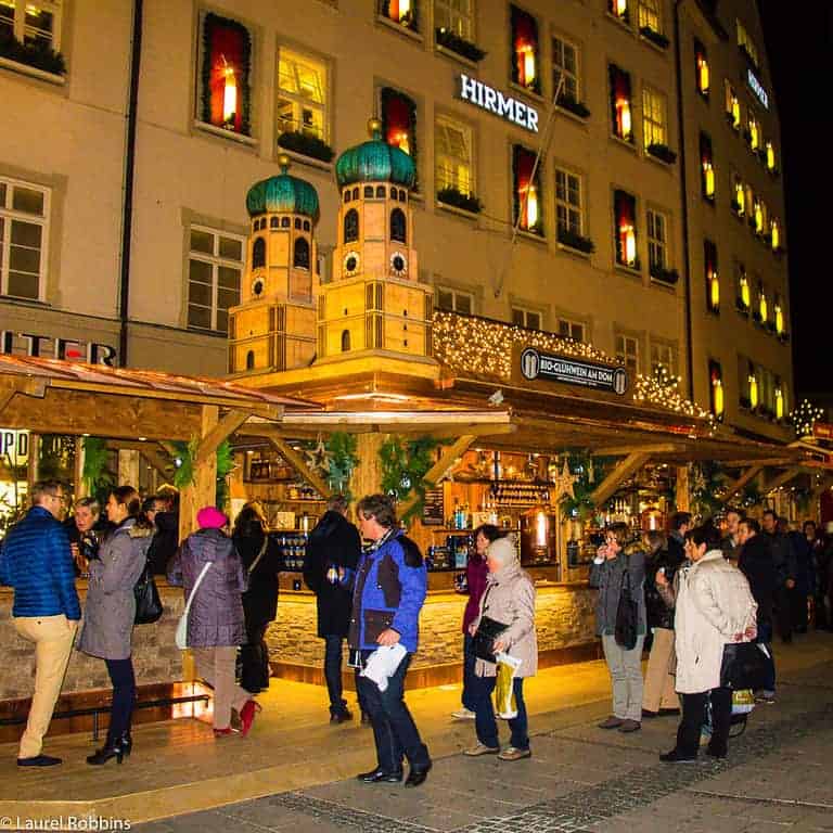 A Glühwein stand that is a replica of the Frauenkirche (church) and in front of it at the Munich Christmas Market.